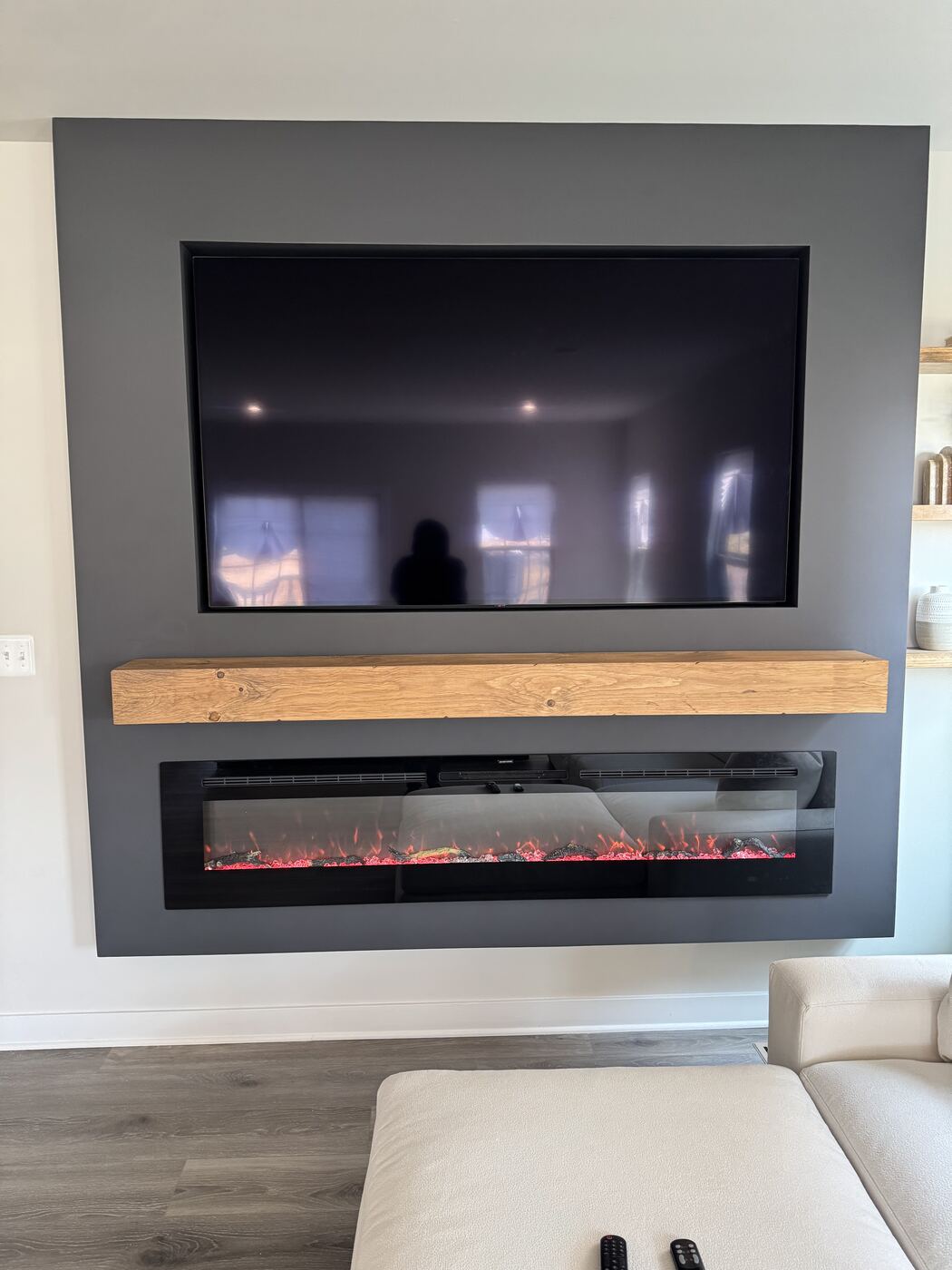 Close view of the oak mantel and the fireplace lit