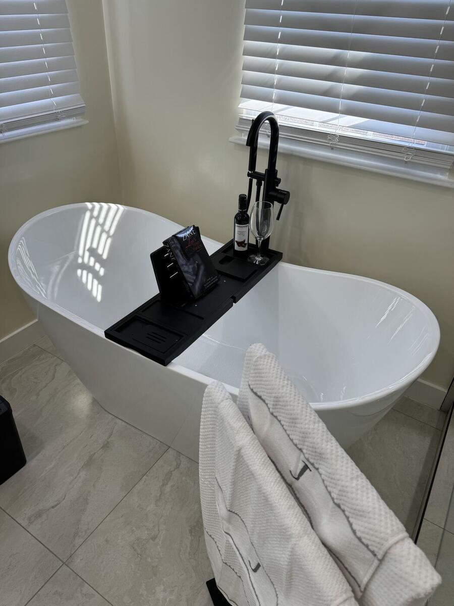 Freestanding tub with black tub filler
