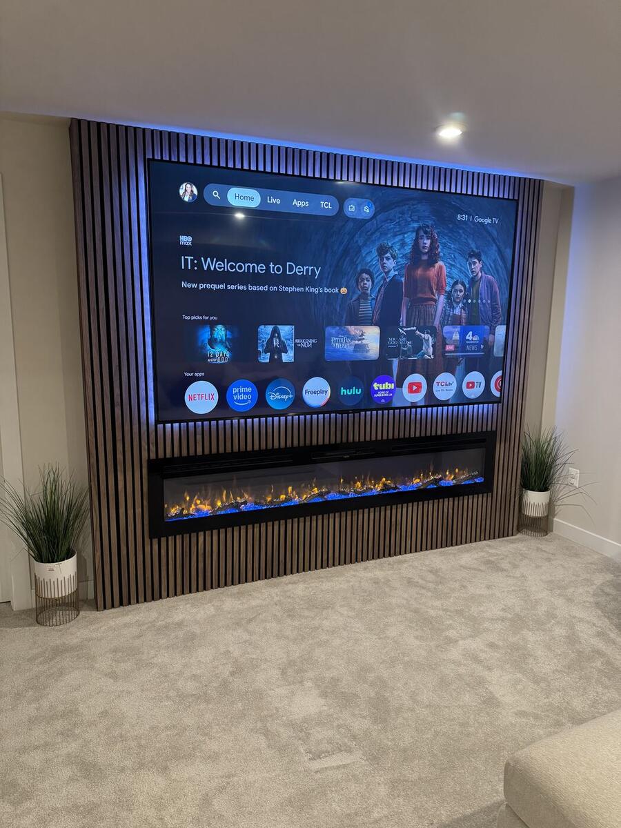 Walnut slat media wall with recessed TV, linear fireplace and LED accent lighting