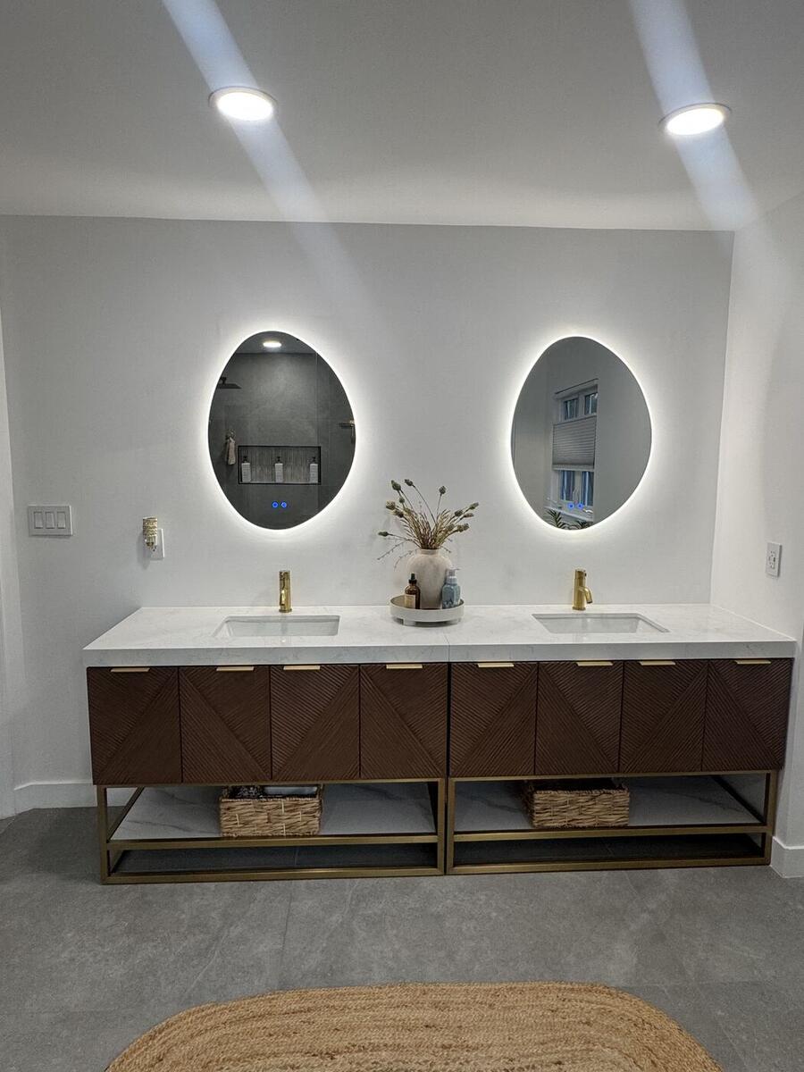 Walnut double vanity with two oval backlit mirrors